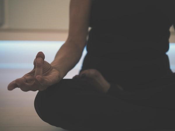 A woman practicing meditation to improve her mental health