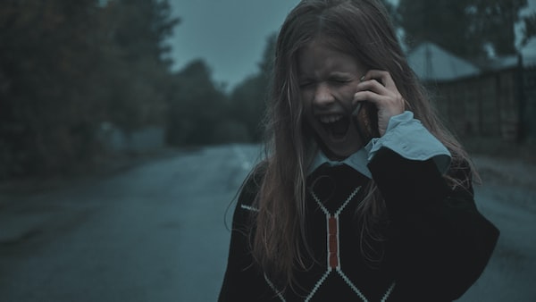 A child experiencing an emotional outburst while using a phone who may benefit from child therapy.